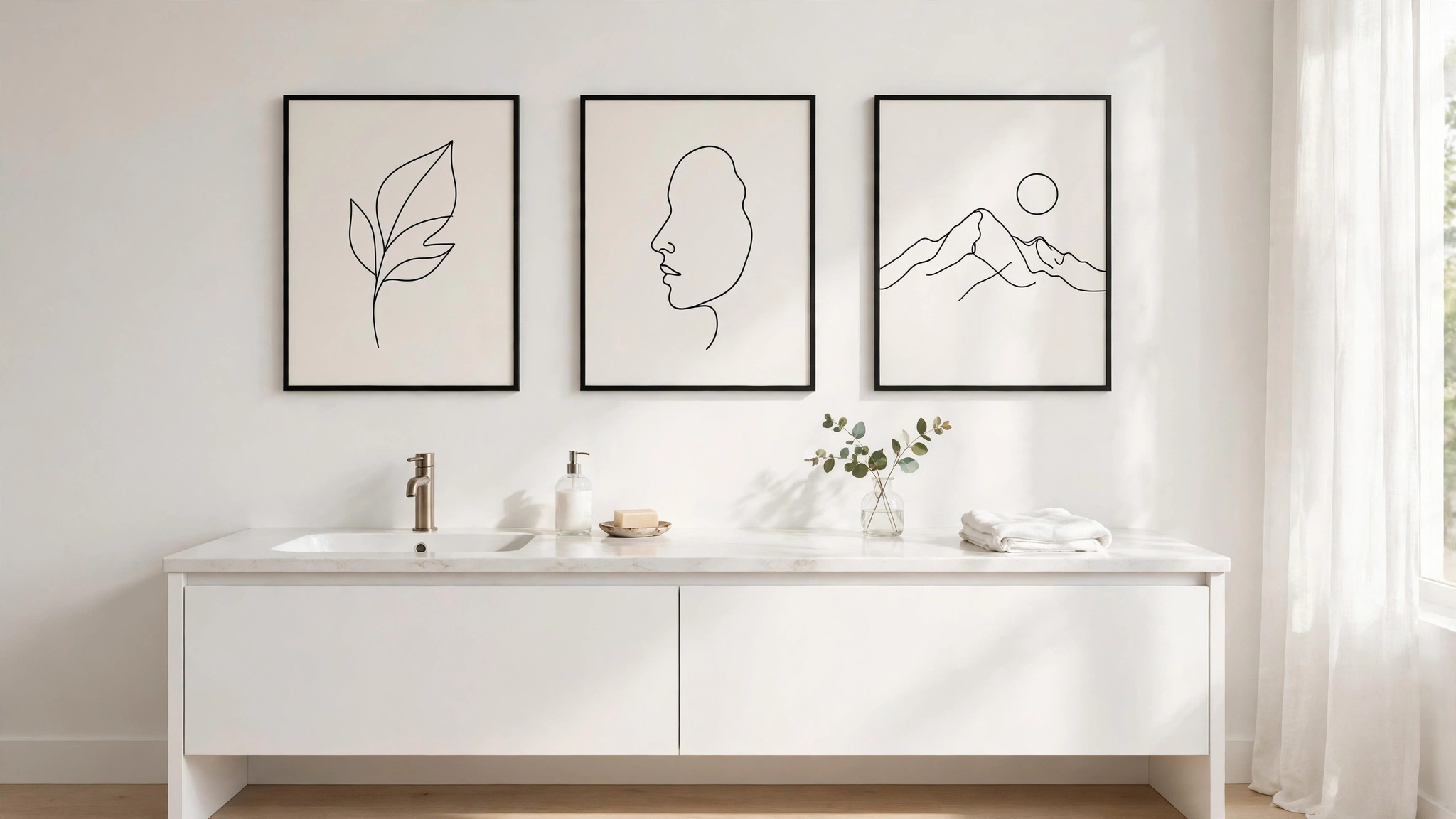 Three minimalist black line art prints in thin black frames hanging in a row on a white bathroom wall
